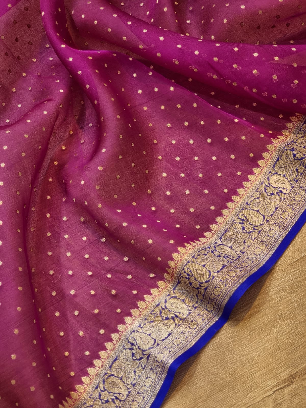 Magenta purple silk saree with small gold zari motifs, featuring an ornate gold and blue border.